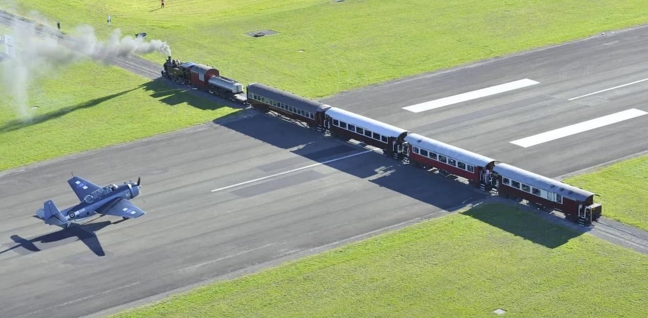 Como é o aeroporto da Nova Zelândia em que aviões e trens se cruzam